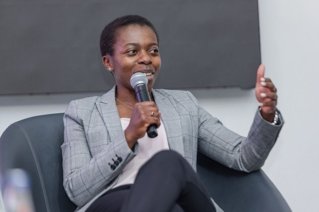 Rumbi speaking on a panel